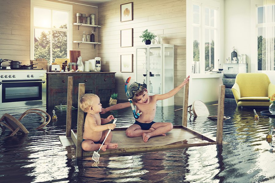 Flood Insurance - Children in the Center of a Flooded Living Room in Bathing Suits and Snorkel Gear